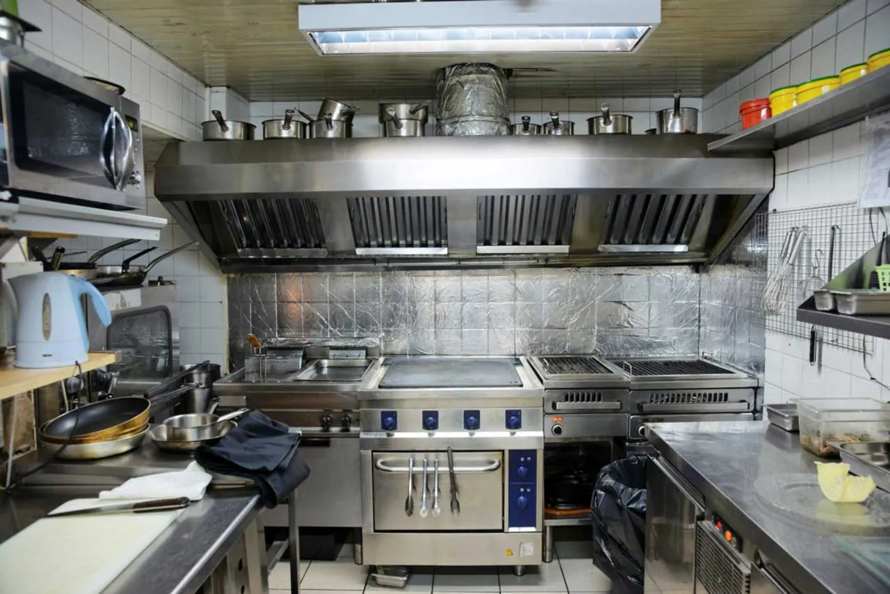 Professional hood cleaning technician servicing a restaurant exhaust system in Reno